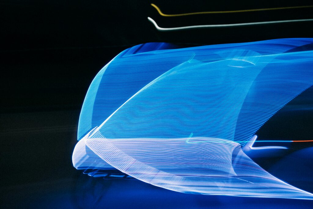 Abstract motion blur of blue light streaks on a black background creating a futuristic visual effect.