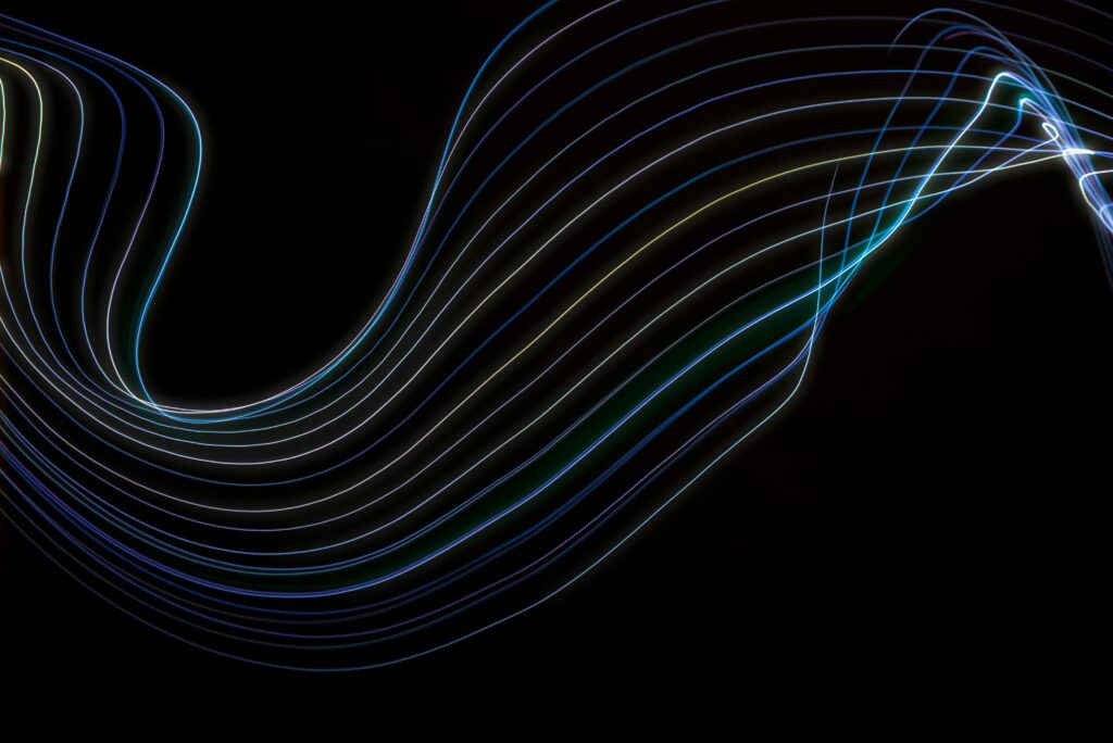 A captivating abstract image featuring colorful light waves on a black backdrop.