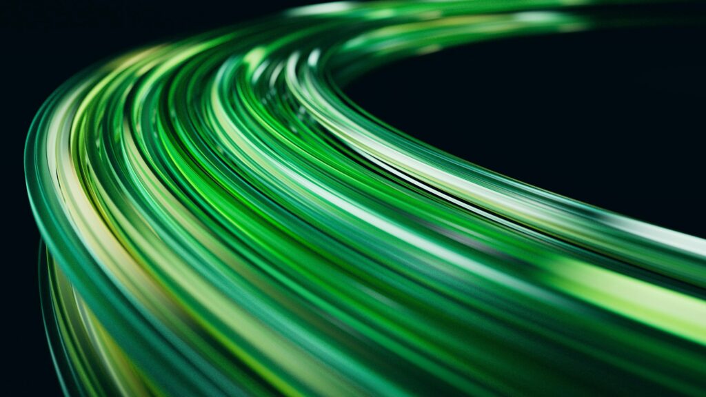 Abstract image of green light trails on a dark background, creating a sense of motion.