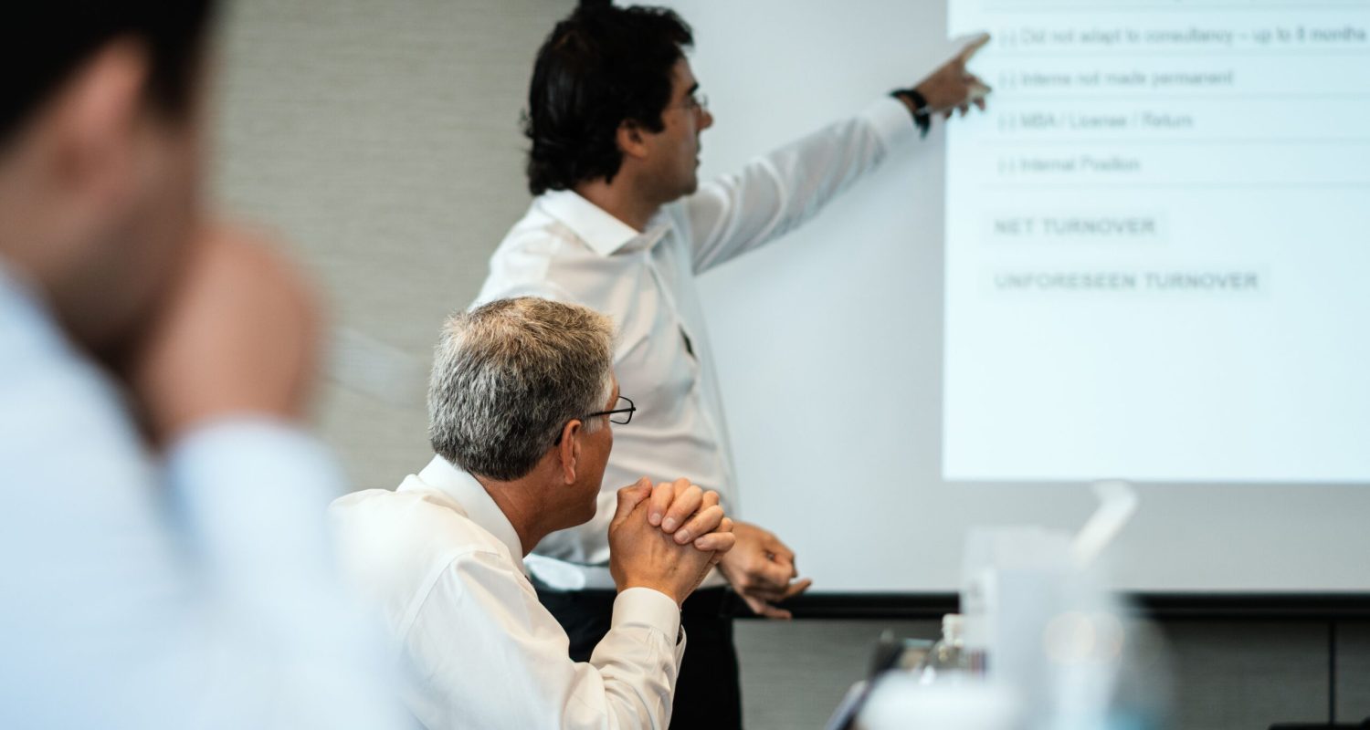 Professional setting with team members focused on a business presentation. Ideal for corporate themes.