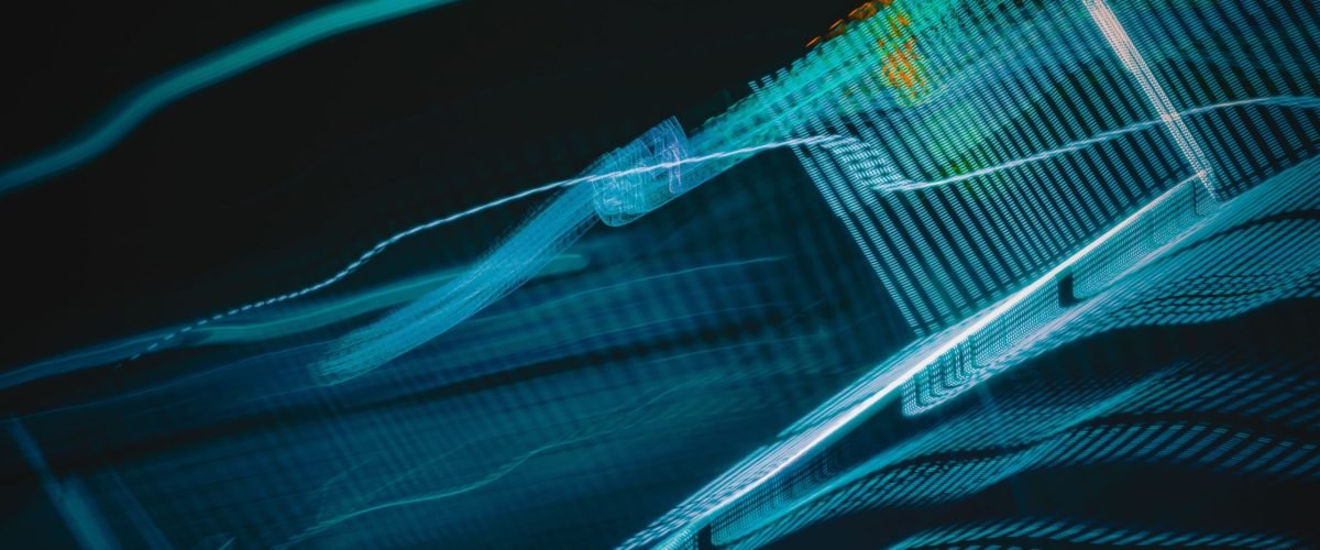 Abstract digital artwork with blue light streaks on a dark background, creating a futuristic feel.